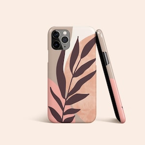 May include: A phone case with a pink and brown abstract design featuring a stylized leaf. The case has a cutout for the camera lens.