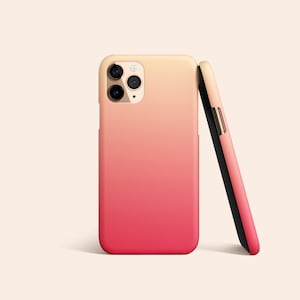 May include: A pink and yellow gradient phone case with a black side view. The case has a camera lens cutout.