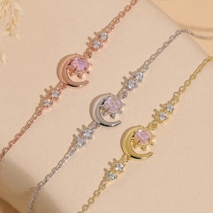 May include: Three delicate bracelets in rose gold, silver, and gold. Each bracelet features a crescent moon and star charm with a pink gemstone, and is accented with small, sparkling crystals. The bracelets are displayed on a neutral background.
