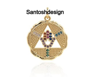 May include: Gold-coloured pendant with a circular frame and a triangle design. The pendant features colourful gemstones and the text "Santoshdesign". The pendant has a textured surface and a loop for a chain.