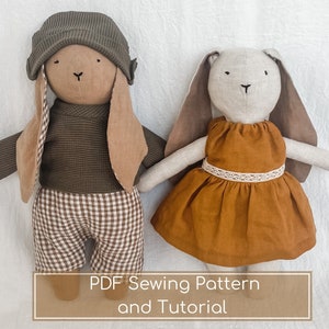May include: Two handmade plush bunny toys, one wearing a brown and white checkered outfit and a brown hat, the other wearing a brown dress with white lace trim. The text "PDF Sewing Pattern and Tutorial" is displayed below the toys.