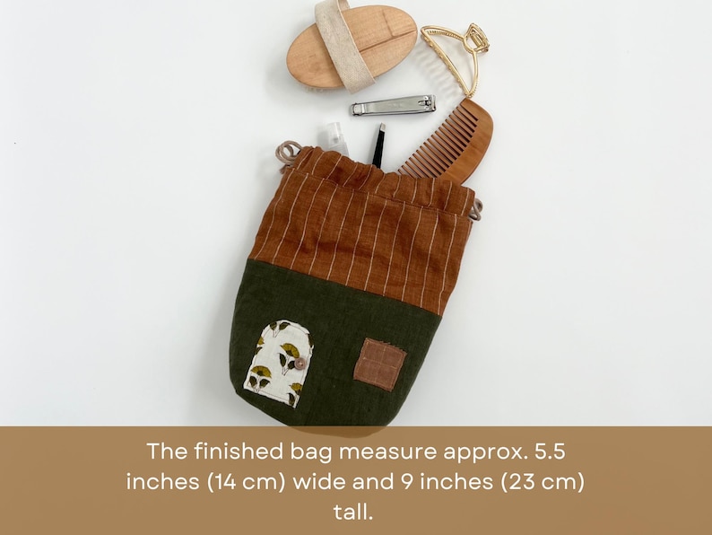 May include: A brown and green drawstring bag with a floral print. The bag measures 5.5 inches wide and 9 inches tall.