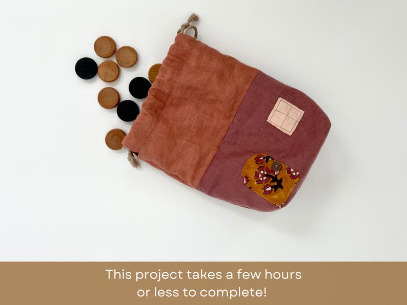 May include: A red and pink fabric drawstring bag with a floral pattern and a button. The bag is filled with wooden game pieces.