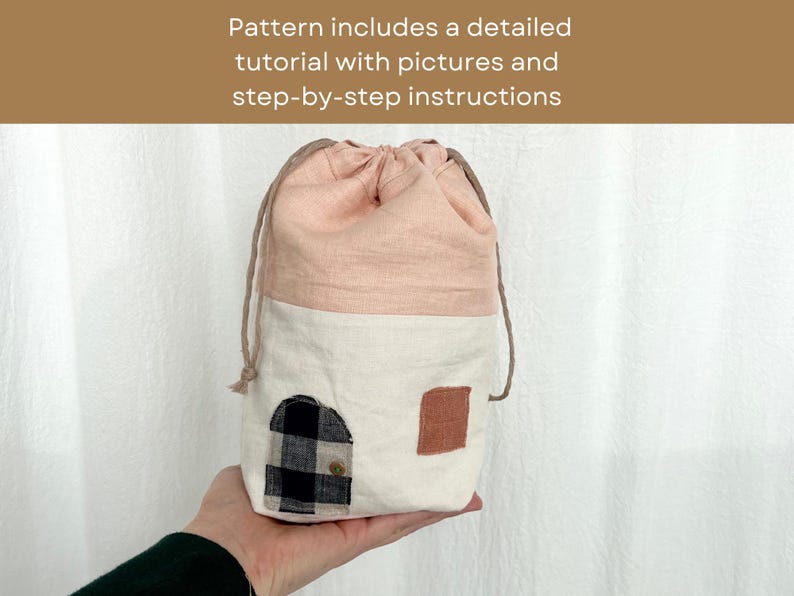 May include: A pink and white drawstring bag with a black and white checkered fabric patch and a brown fabric patch. The bag is made of linen and has a simple design.