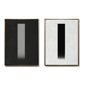 May include: Two framed abstract paintings with a vertical gray stripe on a black background and a vertical black stripe on a white background.