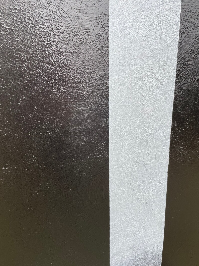 May include: A close-up of a textured surface painted in black and white stripes.