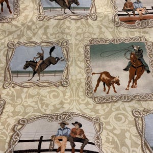 May include: Fabric with a repeating pattern of cowboy scenes framed by rope borders. The scenes depict cowboys riding horses, roping cattle, and sitting on fences. The background is a light beige with a floral design.
