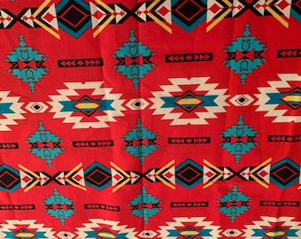 May include: Red fabric with a geometric pattern in shades of blue, yellow, white, and black. The pattern is reminiscent of Native American designs.