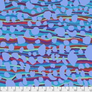 May include: A fabric with a colourful abstract design. The pattern features light blue irregular shapes scattered over a background of wavy lines in shades of blue, red, and green. The fabric is measured with a ruler in inches.