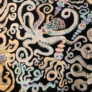 May include: A black fabric featuring a repeating pattern of octopuses and sea creatures in shades of light blue, cream, and soft peach. The octopuses have detailed tentacles and textured heads, interspersed with spiral shells and aquatic forms.