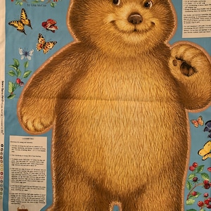 May include: A brown bear applique pattern with a blue background. The pattern includes a bear with a friendly face, berries, and butterflies. The text "Beary Berry Patch" and "by Lisa MeCue" is printed on the pattern.