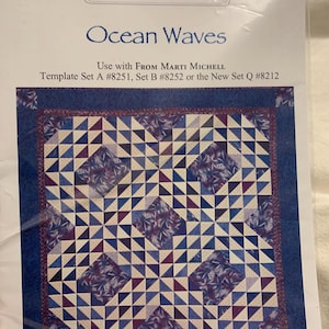 May include: A quilting pattern for a wallhanging called "Ocean Waves" by From Marti and Me. The pattern uses blue, white, and purple fabric to create a wave-like design. The pattern uses templates #8251, #8252, or #8212.