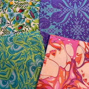 May include: Four fabric swatches with different patterns. One has blue flowers and green leaves on a cream background. Another has a purple paisley design. A third has a green leaf and eye pattern. The last has an abstract pink and orange design.