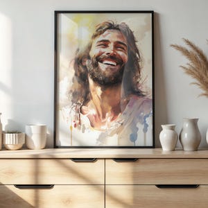 May include: A watercolor painting of a man with long brown hair and a beard smiling. The painting is in a black frame and is hanging on a white wall.