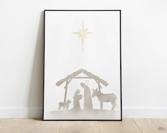 May include: A framed print featuring a minimalist Nativity scene. The artwork depicts a star, a stable, and silhouettes of Mary, Joseph, baby Jesus, a donkey, and a lamb, all in muted tones against a white background. The frame is black.