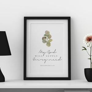 May include: A framed print with a watercolor illustration of a eucalyptus branch. The print features the text "My God will supply every need" and "Philippians 4:19".