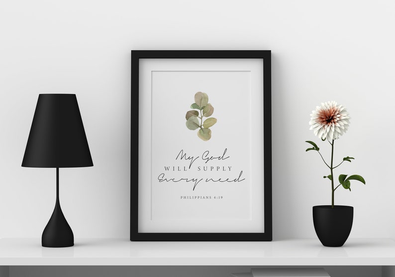 May include: A framed print with a watercolor illustration of a eucalyptus branch. The print features the text "My God will supply every need" and "Philippians 4:19".