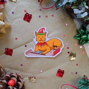 Sticker Chat lutin emballeur de cadeaux de Noël