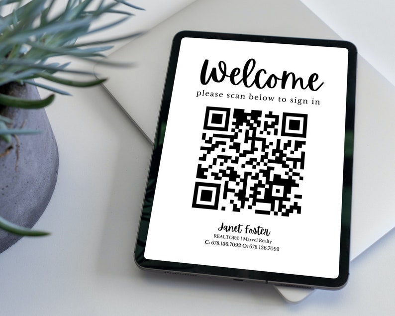May include: A white tablet with a black border displays a welcome message and a black and white QR code. The text reads "Welcome, please scan below to sign in." Below the QR code is the text "Janet Foster, REALTOR | Marvel Realty, C: 678.136.7092 O: 678.136.7093".