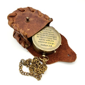 May include: A brass compass with a leather case and chain. The compass face has the inscription "Be Strong and courageous. Do not be afraid; do not be discouraged, for the Lord your God will be with you wherever you go. Joshua 1:9"