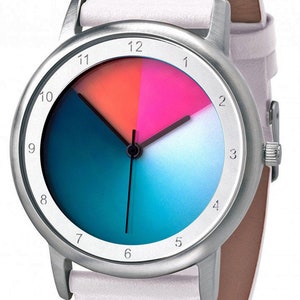 May include: A silver wristwatch with a white leather strap. The watch face has a colourful design with a blue, teal, pink, and orange gradient. The numbers 1 through 12 are printed around the edge of the watch face.