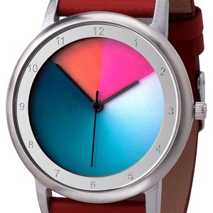 May include: A silver wristwatch with a red leather strap. The watch face has a gradient blue and teal background with a white circle in the centre. The numbers 1 through 12 are printed around the edge of the watch face.