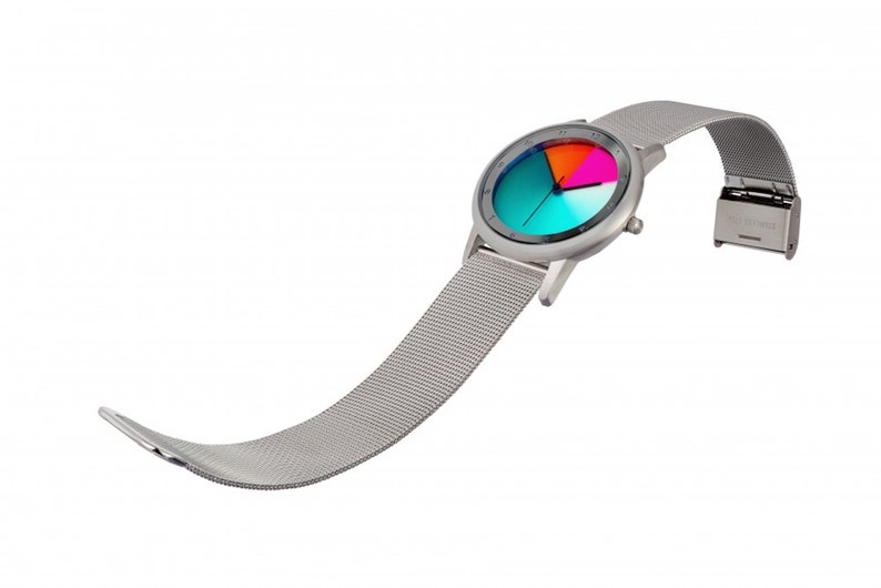 May include: A silver watch with a mesh strap and a colourful face. The face is divided into four sections, each with a different colour: blue, green, orange, and pink.