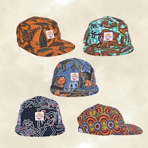 May include: Five colorful, patterned baseball caps. Each cap features a unique design with vibrant colors like orange, blue, and teal. The caps have a flat brim and a small logo patch on the front.