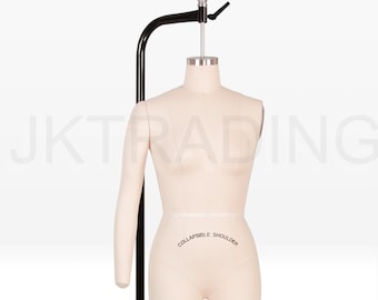 May include: A beige dress form with a black metal stand. The form has a partial arm and is labeled "COLLAPSIBLE SHOULDER". The stand has a height adjustment mechanism. Ideal for dressmaking and fashion design.