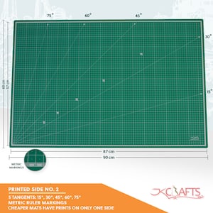 May include: Green self-healing cutting mat with a grid pattern and ruler markings. The mat is 90 cm by 87 cm and has 5 tangents: 15&deg;, 30&deg;, 45&deg;, 60&deg;, 75&deg;.  Printed side no. 2.  Cheaper mats have prints on only one side.