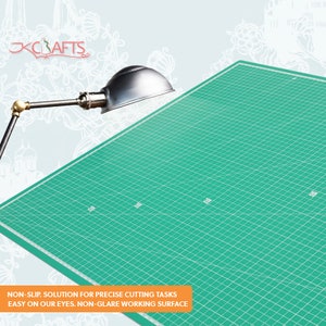 May include: A green self-healing cutting mat with a grid pattern. The mat is designed to be non-slip and non-glare, making it easy on the eyes.  NON-SLIP. SOLUTION FOR PRECISE CUTTING TASKS EASY ON OUR EYES. NON-GLARE WORKING SURFACE