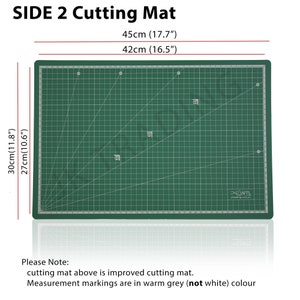 May include: Green self-healing cutting mat with grid lines and measurement markings in grey. The mat measures 17.7 inches by 16.5 inches. The mat is made by X-Crafts.