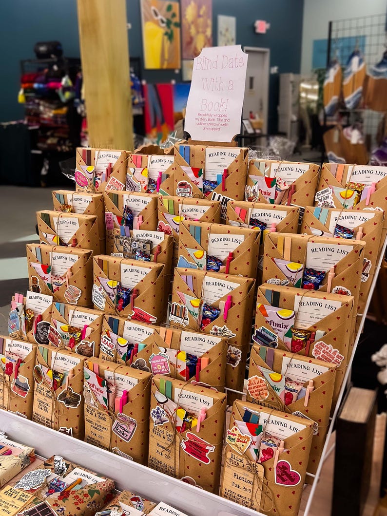 May include: A shelf display of brown paper wrapped packages with colorful stickers and ribbons. The packages are labeled "Reading List" and "Blind Date With a Book!"