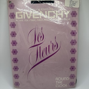 May include: Givenchy pantyhose in a light purple package, with floral side stripes. The packaging features the text "Les Fleurs" in a cursive font, and "Round the Clock". A sticker indicates the pantyhose are Le Jet Black.