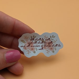 May include: A white sticker with a floral border and the text "all shall be well, and all shall be well, and all manner of things shall be well."