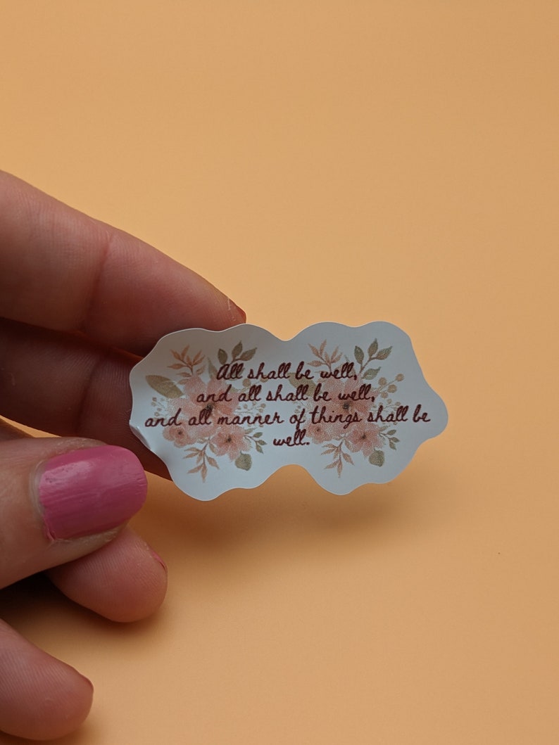 May include: A white sticker with a floral border and the text "all shall be well, and all shall be well, and all manner of things shall be well."