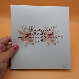May include: A white card with a floral design and the text "All shall be well, and all shall be well, and all manner of things shall be well." The card has the number 09 printed in the bottom right corner.