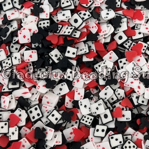 May include: A close-up image of a variety of colourful, small, plastic, playing card and dice charms. The charms are red, black, and white. The charms are perfect for adding a fun and whimsical touch to crafts, jewellery, and other projects.