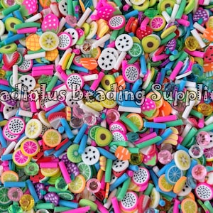 May include: A vibrant assortment of polymer clay fruit slices and colorful rod beads. The mix includes watermelon, lemon, kiwi, and dragon fruit, in shades of pink, green, yellow, and blue. The text "Gladiolus Beading Supplies" is visible.