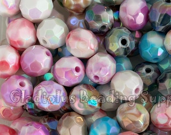 May include: A collection of iridescent faceted round beads in various colors, including pink, blue, white, and brown. The beads have a textured, honeycomb-like surface.