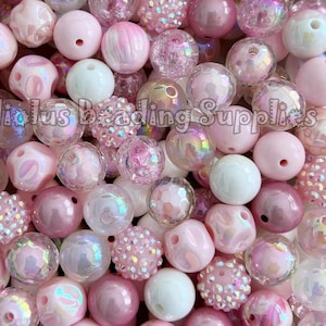 May include: A large assortment of pink and white beads, including iridescent, clear, and textured styles. The beads are perfect for crafting jewellery, accessories, and other projects.