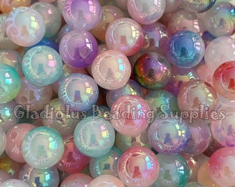 May include: A pile of iridescent beads in various pastel colors, including pink, purple, blue, and green. The beads are round and have a glossy finish, reflecting light. The text "Gladiolus Beading Supplies" is visible.