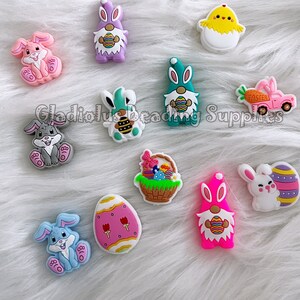 May include: A set of 10 colorful Easter-themed silicone charms featuring bunnies, chicks, gnomes, eggs, and a basket of Easter eggs. The charms are perfect for adding a festive touch to crafts, jewelry, and other projects.