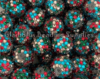 May include: Close-up of a pile of round beads. The beads are covered in small, colorful rhinestones in red, green, blue, and silver. The text "Gladiolus Beading Supplies" is visible at the bottom.