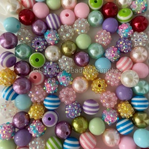 May include: A collection of colorful beads in various shapes and patterns, including striped, glittery, and solid colors. The beads are made of plastic and are perfect for crafting jewelry or other projects.