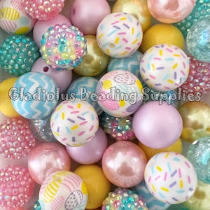 May include: A collection of colorful, patterned beads in various shapes and sizes. The beads are made of plastic and have a variety of designs, including sprinkles, polka dots, and zigzags. Gladiolus Beading Supplies is printed on the image.