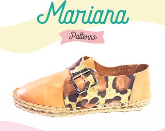 May include: Tan leather espadrille shoe with a buckle closure and a leopard print detail. The shoe is made by Mariana Patterns.