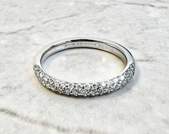 May include: A silver band with a row of small diamonds on the top and bottom of the band. The band is inscribed with "DFHNYC HK" on the inside.