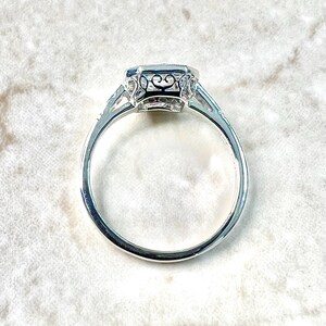 May include: A silver ring with a large, octagonal-shaped gemstone set in a filigree design.