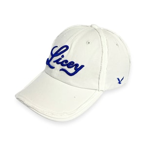 May include: White baseball cap with a blue embroidered logo that says "Liccy" and a small blue bird logo on the side.